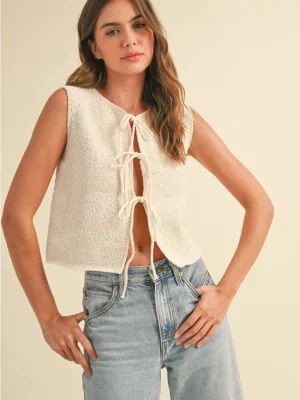 Textured tie-front sleeveless top with open front and cropped fit.